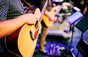 acoustic guitarists playing in a church band