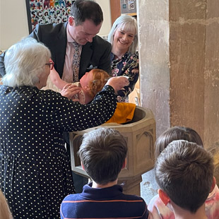 a baptism conducted by Local Minister Sue Deacon at Scampton church