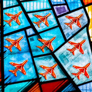 Red Arrows jets depicted in stained glass within the RAF Scampton Commemorative Window at Scampton Church